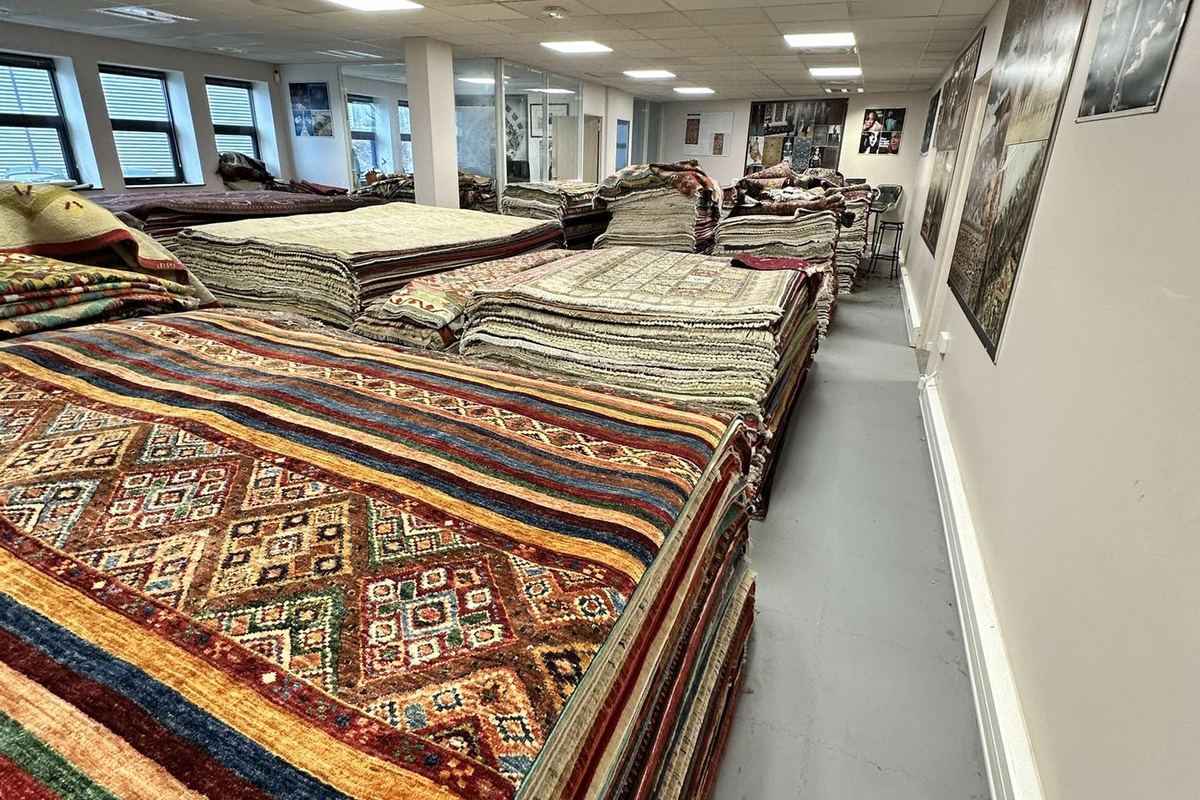 Stacks of Oriental rugs in one of La Maison de la Perse's warehouses
